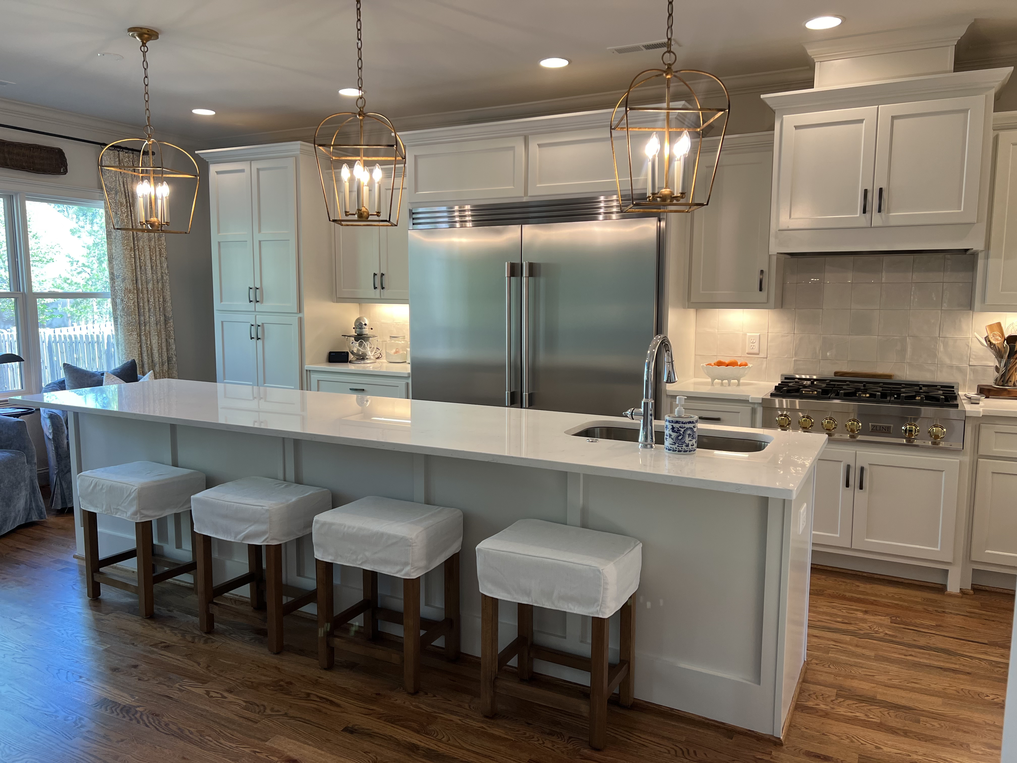 Custom kitchen with brass pendant lighting